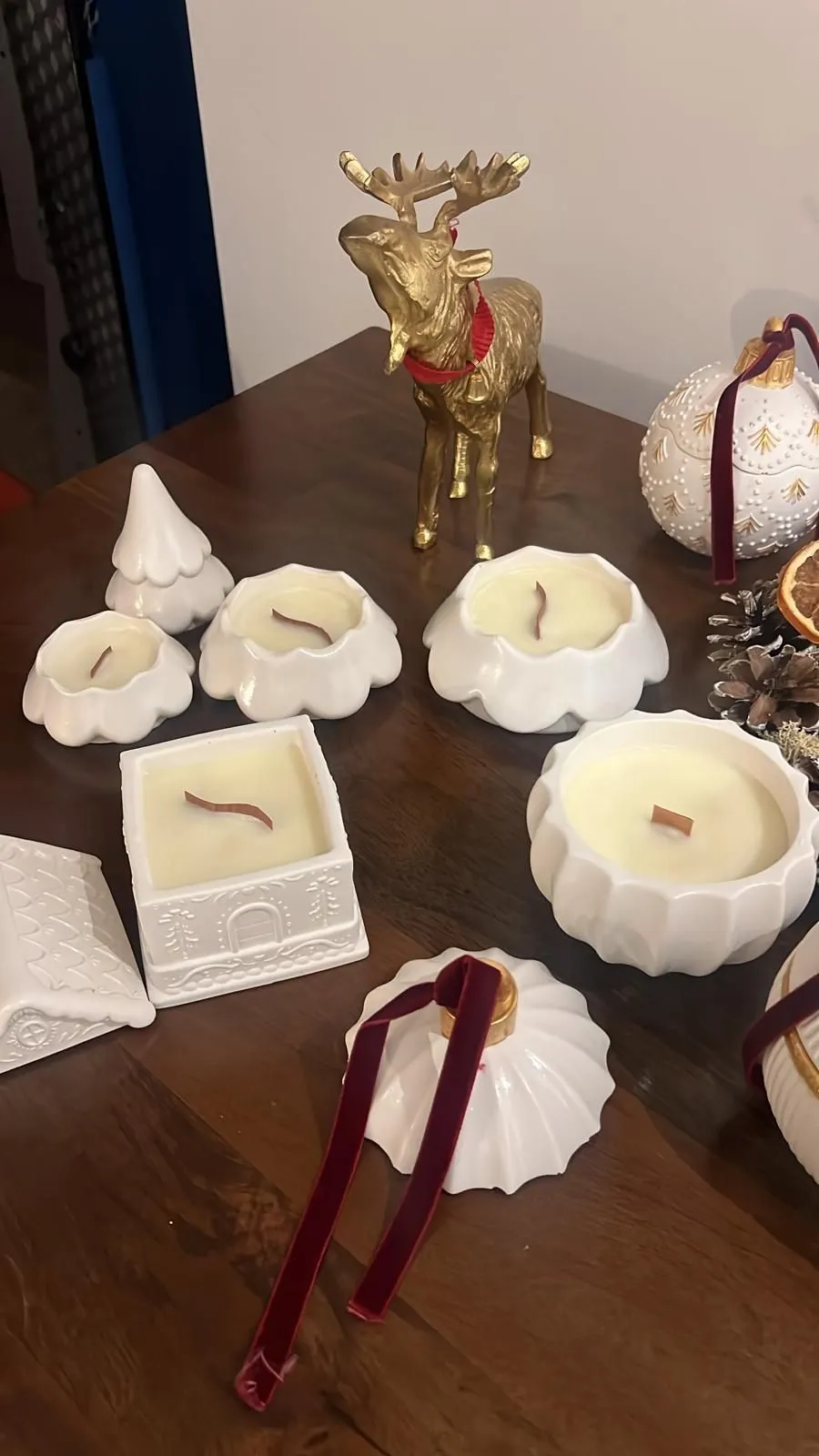 Festive handmade ceramic candle vessels on a styled table
